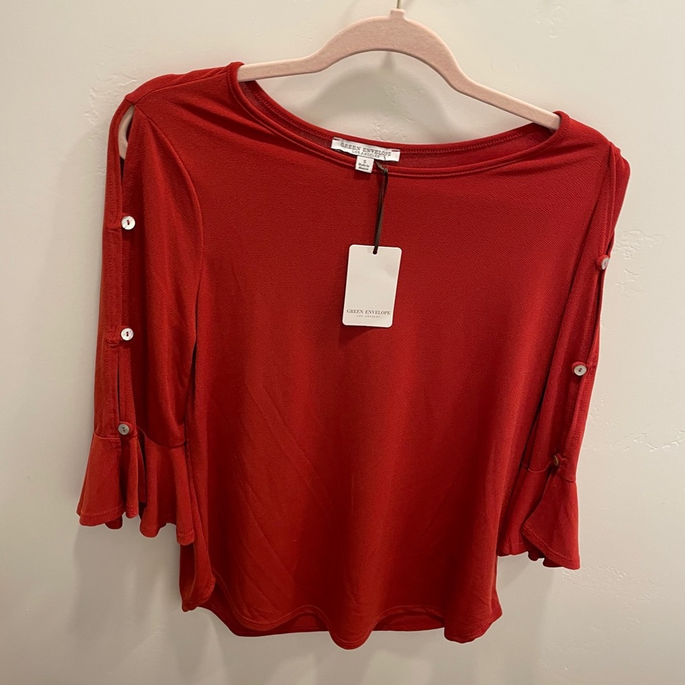 New burnt orange blouse with cropped sleeves.